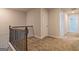 Upstairs hallway featuring carpet flooring and wood railing at 412 Barley Lot 86 Ct, Covington, GA 30014