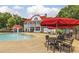 Resort-style pool featuring patio dining and sun umbrellas with the main building in the background at 412 Barley Lot 86 Ct, Covington, GA 30014