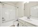 Bright bathroom with a shower-tub combo, white vanity, and a clean, modern aesthetic at 310 Nw Brightfield Dr, Loganville, GA 30052