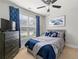 Comfortable bedroom with blue accents, a large window, and ample natural light at 310 Nw Brightfield Dr, Loganville, GA 30052