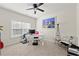Bright bedroom with lots of natural light, modern desk setup, and seating area at 310 Nw Brightfield Dr, Loganville, GA 30052