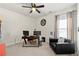 Versatile bedroom space with office setup, cozy seating, and ample natural light at 310 Nw Brightfield Dr, Loganville, GA 30052