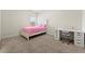 Charming bedroom with plush pink accents, a cozy bed, and a stylish vanity area at 310 Nw Brightfield Dr, Loganville, GA 30052