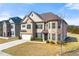 Beautiful brick home with a well-maintained lawn and an attached two-car garage at 310 Nw Brightfield Dr, Loganville, GA 30052
