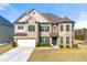 Stunning two-story brick home showcasing manicured lawn and attached two-car garage at 310 Nw Brightfield Dr, Loganville, GA 30052
