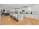 Bright, open kitchen with a center island, barstool seating, and white cabinetry at 310 Nw Brightfield Dr, Loganville, GA 30052