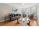 Cozy living room featuring a comfortable sofa, chairs, and a unique coffee table at 310 Nw Brightfield Dr, Loganville, GA 30052
