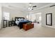 Spacious main bedroom featuring a ceiling fan, tray ceiling, and ample natural light from large windows at 310 Nw Brightfield Dr, Loganville, GA 30052