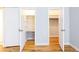 Two open closets showing shelving and closet rods with hardwood flooring in the bedrooms at 430 Lindbergh Ne Dr # M1, Atlanta, GA 30305