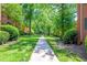 Well-manicured walkway through lush green lawns and mature trees in a tranquil community at 430 Lindbergh Ne Dr # M1, Atlanta, GA 30305