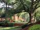 Exterior view of the brick condominiums featuring beautiful landscaping and mature trees at 430 Lindbergh Ne Dr # M1, Atlanta, GA 30305
