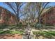 Exterior of the brick condominiums featuring a walkway, lush landscaping, and mature trees at 430 Lindbergh Ne Dr # M1, Atlanta, GA 30305