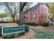 Brick condominium community with mature trees, a lush lawn and a well-maintained landscape at 430 Lindbergh Ne Dr # M1, Atlanta, GA 30305