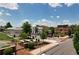 Charming neighborhood featuring sidewalks, mature trees, and local shops under a bright blue, partly cloudy sky at 110 Chiswick Cir # 40, Alpharetta, GA 30009