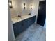 Bathroom featuring double vanity sinks, a marble floor, modern fixtures, and a dark paneled door at 110 Chiswick Cir # 40, Alpharetta, GA 30009
