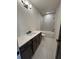 Modern bathroom with a sleek vanity, white countertops, tiled floor and a shower-tub combination at 110 Chiswick Cir # 40, Alpharetta, GA 30009