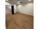 Neutral bedroom with hardwood floors, a ceiling fan, and a dark door leading out to a stairway with metal handrails at 110 Chiswick Cir # 40, Alpharetta, GA 30009