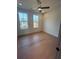 Bedroom featuring hardwood floors, a ceiling fan, and two large windows for natural light at 110 Chiswick Cir # 40, Alpharetta, GA 30009