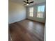 Bedroom with hardwood floors, a ceiling fan, and two large windows for natural light at 110 Chiswick Cir # 40, Alpharetta, GA 30009