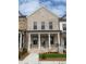 Charming two-story townhome boasts a light brick facade, covered porch, and well-manicured lawn at 110 Chiswick Cir # 40, Alpharetta, GA 30009