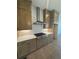 Kitchen featuring natural wood cabinetry, a range hood, and stainless steel appliances against neutral walls at 110 Chiswick Cir # 40, Alpharetta, GA 30009