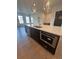 Close-up of a kitchen island with white countertops, dark wood cabinets, and a stainless steel microwave at 110 Chiswick Cir # 40, Alpharetta, GA 30009