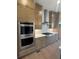 Modern kitchen with stainless steel appliances, updated cabinets, and a large island with room for seating at 110 Chiswick Cir # 40, Alpharetta, GA 30009