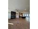 Open-concept living room with a modern fireplace, ceiling fan, and hardwood floors, next to the kitchen with a large island at 110 Chiswick Cir # 40, Alpharetta, GA 30009