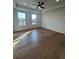 Spacious main bedroom with tray ceilings, two windows, and hardwood flooring at 110 Chiswick Cir # 40, Alpharetta, GA 30009