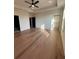 Spacious main bedroom features hardwood floors, a ceiling fan, and ample natural light at 110 Chiswick Cir # 40, Alpharetta, GA 30009