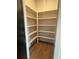 Spacious pantry providing ample storage space, complete with multiple shelves and hardwood flooring at 110 Chiswick Cir # 40, Alpharetta, GA 30009
