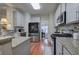 Well-lit kitchen with stainless steel appliances, granite countertops, white subway tile backsplash, and hardwood floors at 5690 Stonekirk Nw Pl, Acworth, GA 30101