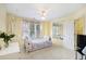 Bright bedroom featuring carpet, a ceiling fan, sunny windows, and cream-colored walls at 6142 Arden Ct, Douglasville, GA 30135