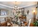 Sophisticated dining room with stylish chandelier, decorative walls, and a glass top table at 6142 Arden Ct, Douglasville, GA 30135