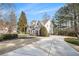 A stunning two story house with a concrete driveway and lush green shrubbery at 6142 Arden Ct, Douglasville, GA 30135