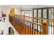 Upstairs hallway with hardwood floors and iron railing overlooking the first floor at 6142 Arden Ct, Douglasville, GA 30135