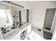 Bright bathroom featuring a double sink vanity, tile floors and separate tub and toilet areas at 849 Kirsten Jane Ct, Lawrenceville, GA 30045