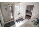 Bright bathroom with a glass-enclosed shower, soaking tub, and double sink vanity at 849 Kirsten Jane Ct, Lawrenceville, GA 30045