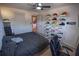 Bedroom with a bed, ceiling fan, and displays of shoes on decorative shelving and in storage containers at 849 Kirsten Jane Ct, Lawrenceville, GA 30045
