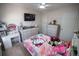 This bedroom includes a vanity desk, a bed with decorative bedding, and a ceiling fan at 849 Kirsten Jane Ct, Lawrenceville, GA 30045