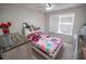 Bedroom features a bed, a dresser, and a large window that brings in lots of natural light at 849 Kirsten Jane Ct, Lawrenceville, GA 30045