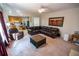 Comfortable living room with a large leather sectional sofa, plush carpet, and adjoins the eat-in kitchen at 849 Kirsten Jane Ct, Lawrenceville, GA 30045