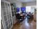 Office features a large desk, storage cabinets, dual monitors, and access to the rest of the home at 849 Kirsten Jane Ct, Lawrenceville, GA 30045