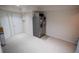 This empty room has white walls, carpet floors, a refrigerator, and white doors at 849 Kirsten Jane Ct, Lawrenceville, GA 30045