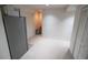 This empty room contains white walls, carpet floors, a refrigerator, and white doors at 849 Kirsten Jane Ct, Lawrenceville, GA 30045