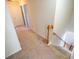 Carpeted stairs with wooden handrail and white trim offer a transition to the next level at 849 Kirsten Jane Ct, Lawrenceville, GA 30045