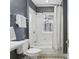 This bathroom features a tub, tiled walls, window, and decorative tile flooring at 272 14Th Ne St # 18, Atlanta, GA 30309