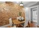 Charming dining room with exposed brick wall and hardwood floors next to bathroom at 272 14Th Ne St # 18, Atlanta, GA 30309