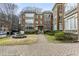 Exterior elevation view of multi-story brick building with lush landscaped grounds at 272 14Th Ne St # 18, Atlanta, GA 30309