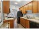 Efficient kitchen with wooden cabinetry, tiled countertops, and black appliances at 272 14Th Ne St # 18, Atlanta, GA 30309